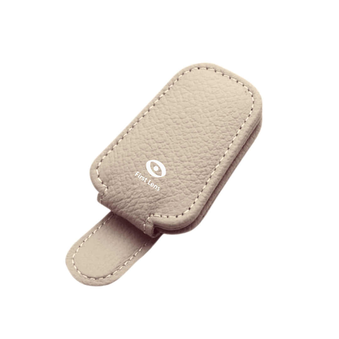 First Lens Magnetic Sunglasses Holder securely attached to a car visor, holding a pair of sunglasses