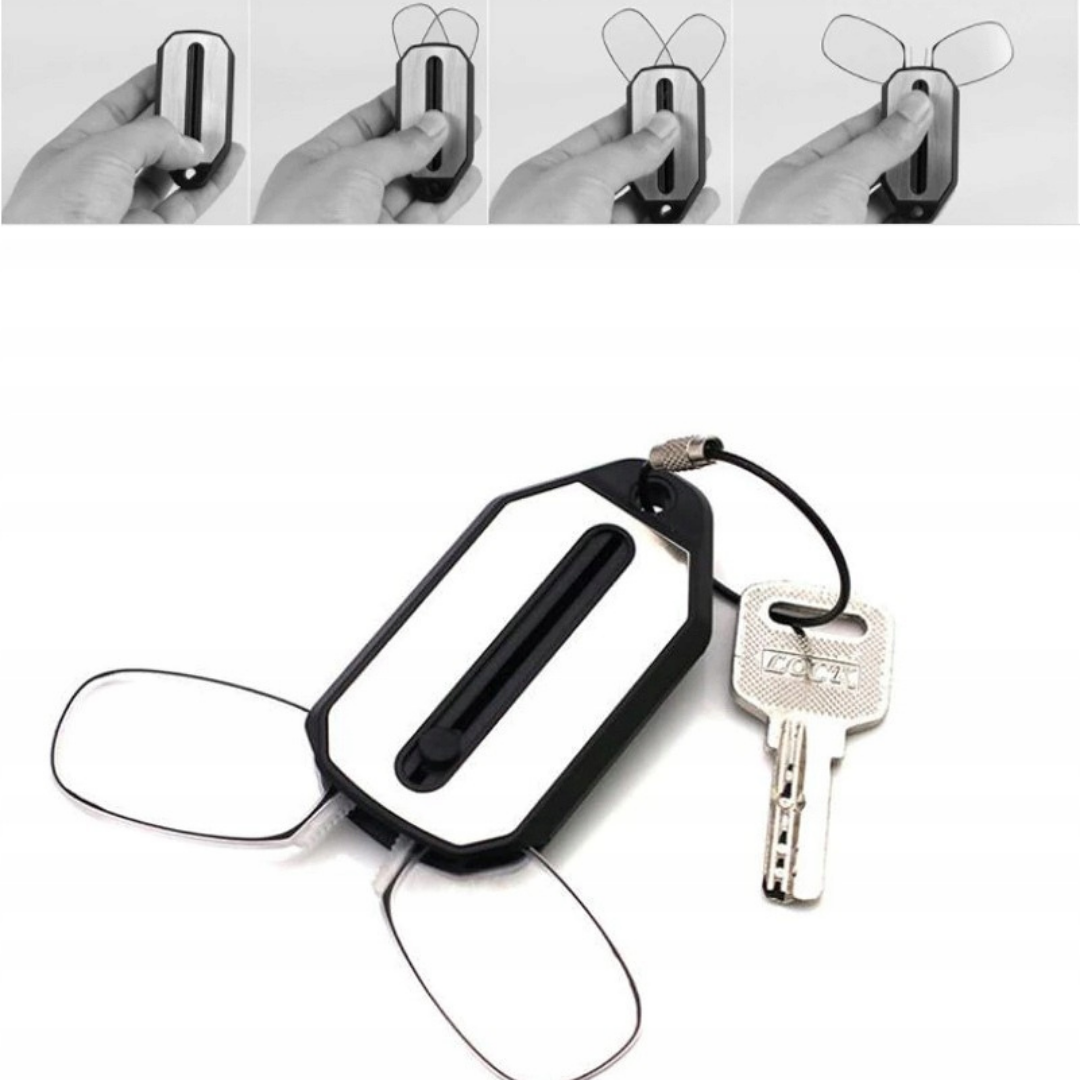 First Lens Mini Nose Clip Reading Glasses resting on a magazine