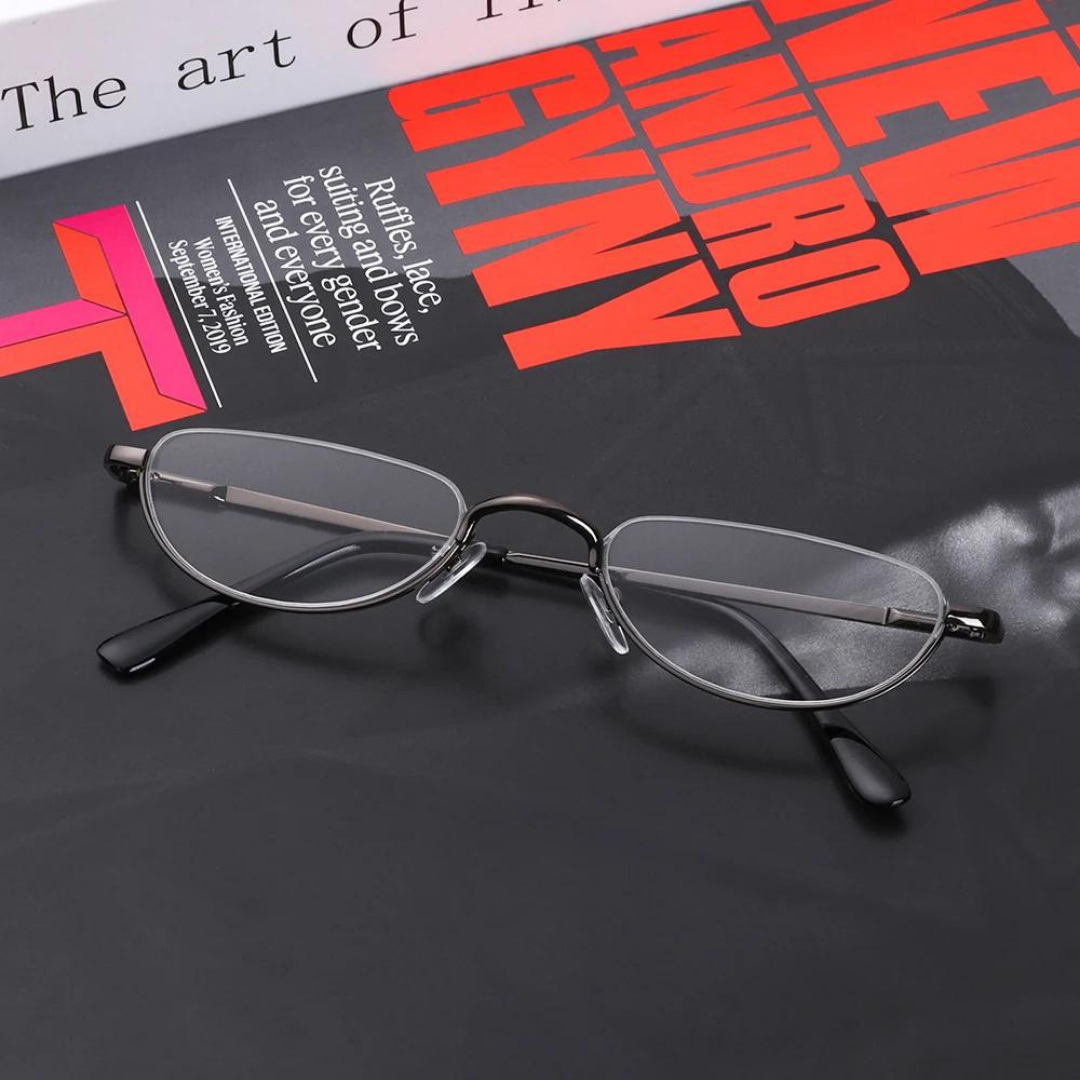 Person placing First Lens Agile Oval reading glasses RG_1027 on a table