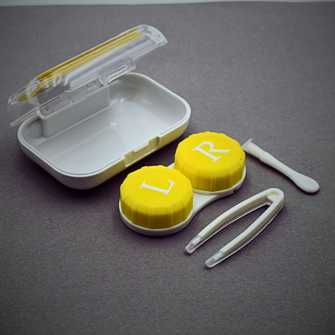 A stylish and compact contact lens case made of crystal-clear material, perfect for traveling.