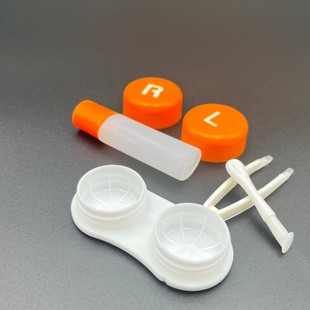 A close-up image of a fruit-shaped contact lens case from First Lens.
