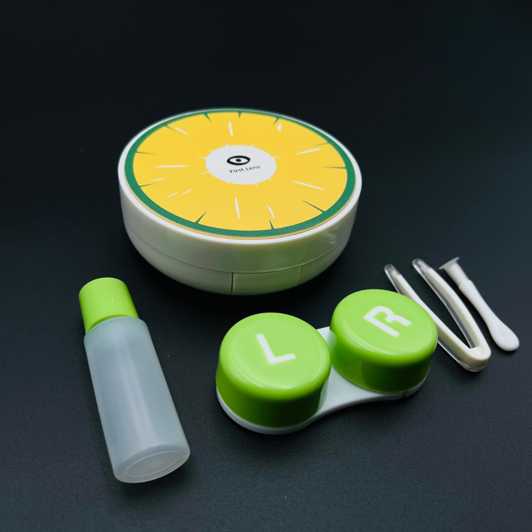 A colorful contact lens case shaped like a strawberry by First Lens, perfect for storing your lenses.