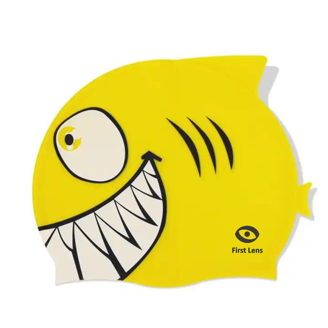 Child with a swim cap by First Lens featuring a cute shark design.