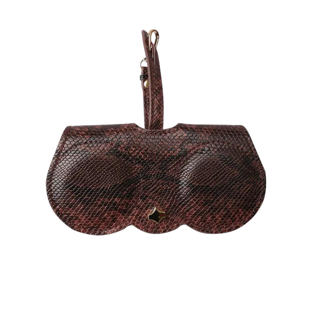 The First Lens case hanging from a hook, ideal for storage in various locations.