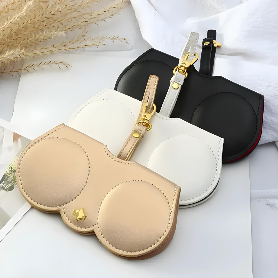 A sleek, black leather eyeglasses clip case from First Lens with a magnetic closure, perfect for storing eyeglasses or sunglasses.