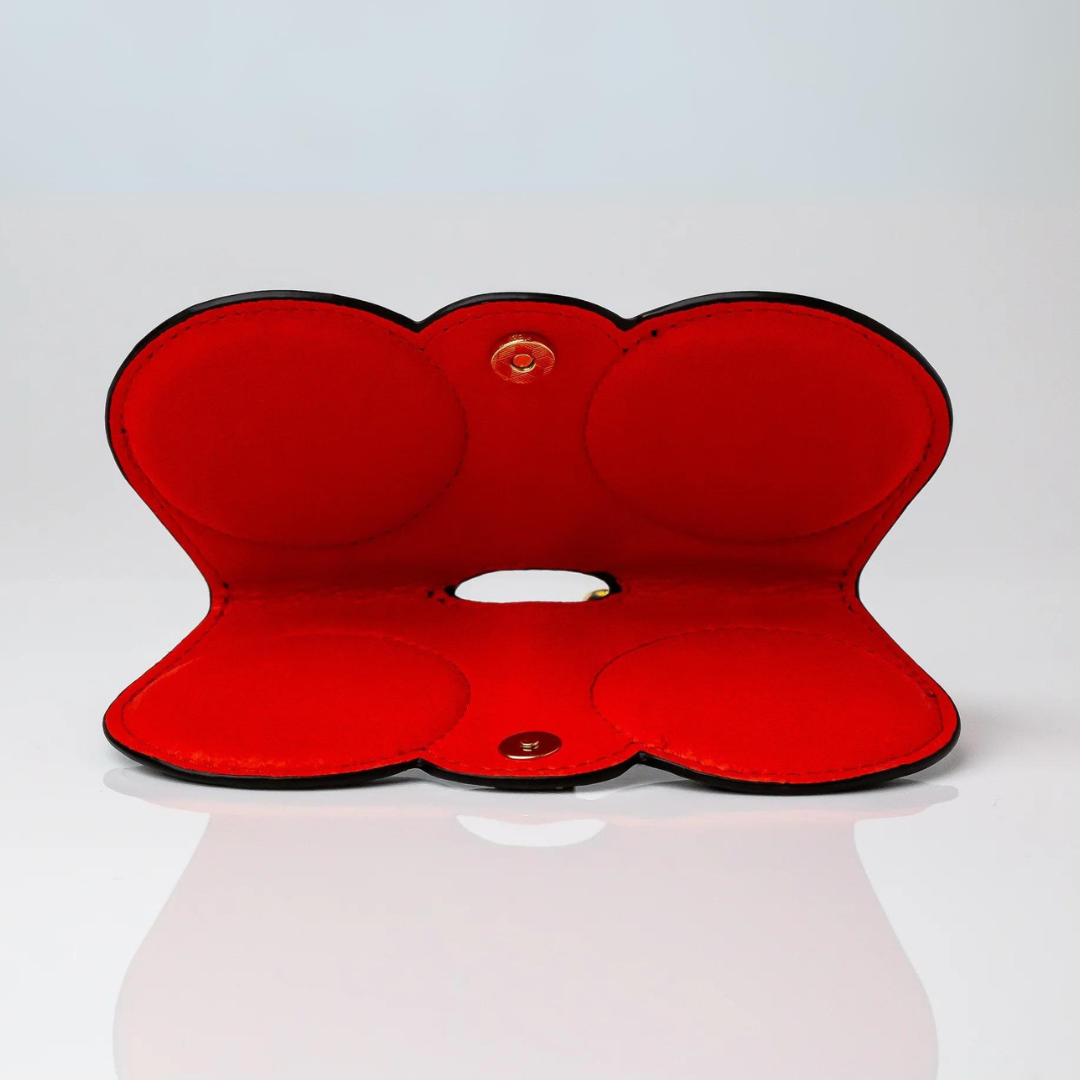 An image showing the First Lens eyeglasses clip case opened to reveal its soft interior lining, ideal for safely storing glasses.