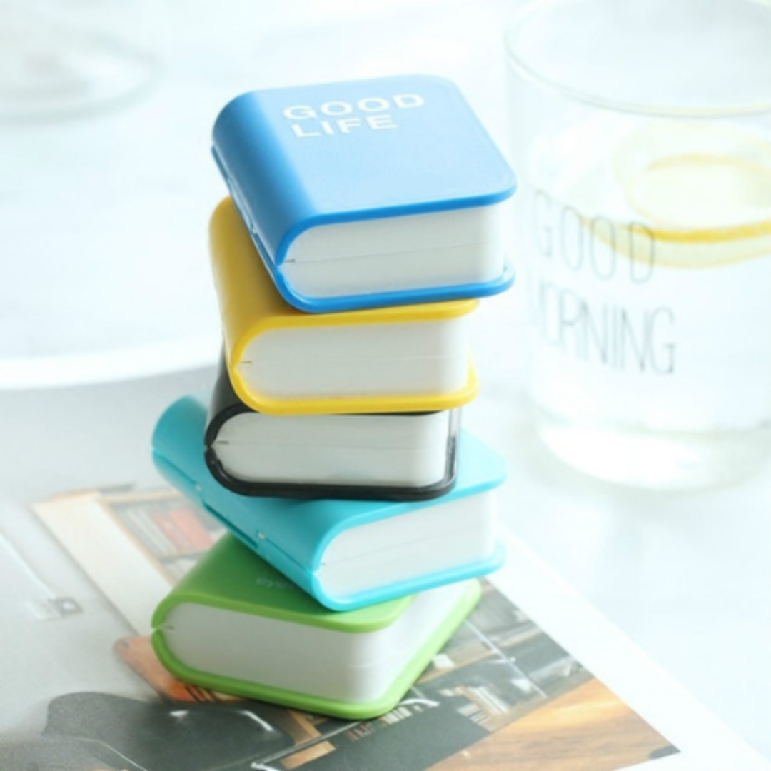 A trendy contact lens holder resembling a book, combining fashion and functionality in one accessory.