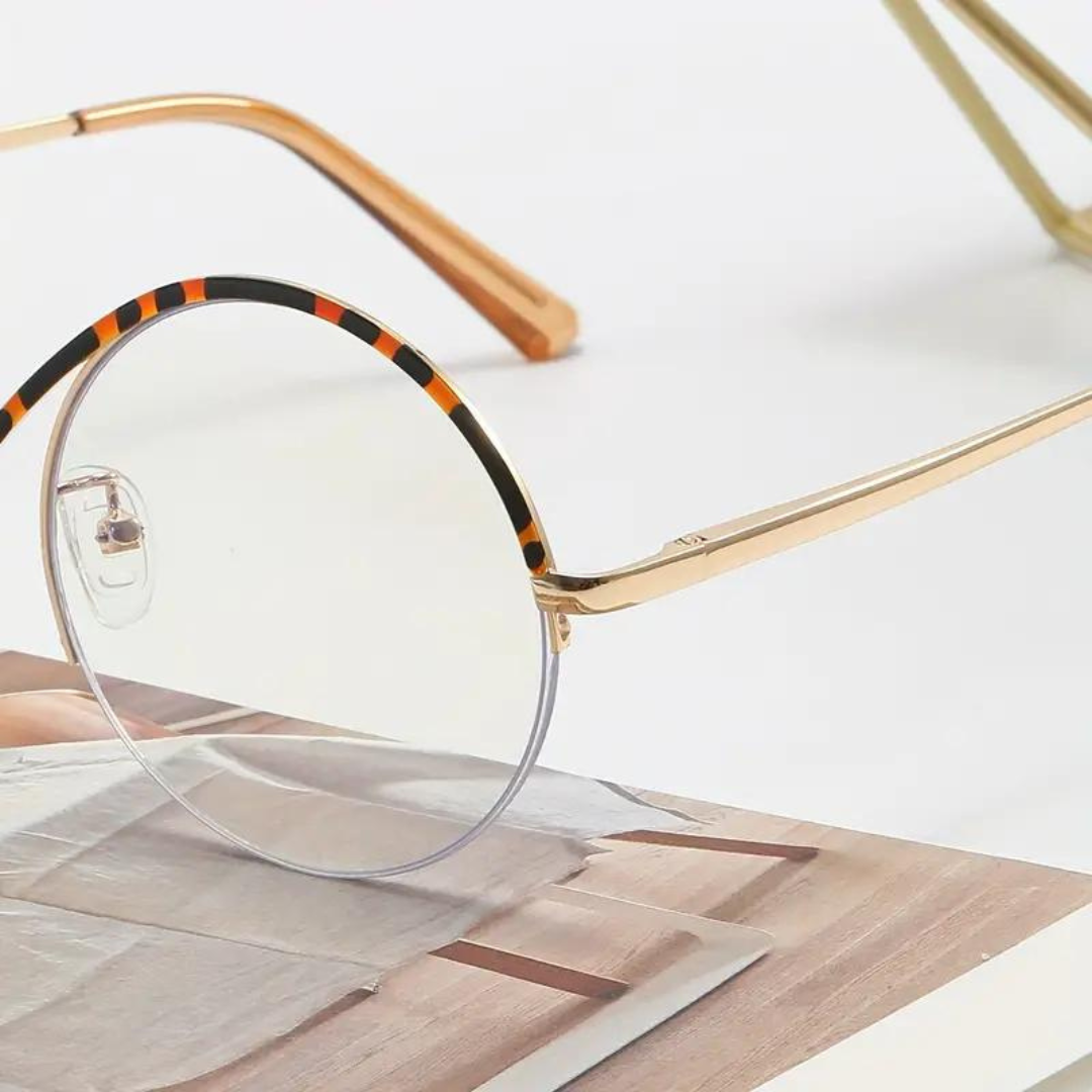 A pair of leopard-print computer glasses from First Lens Infinity, featuring sleek and modern design.