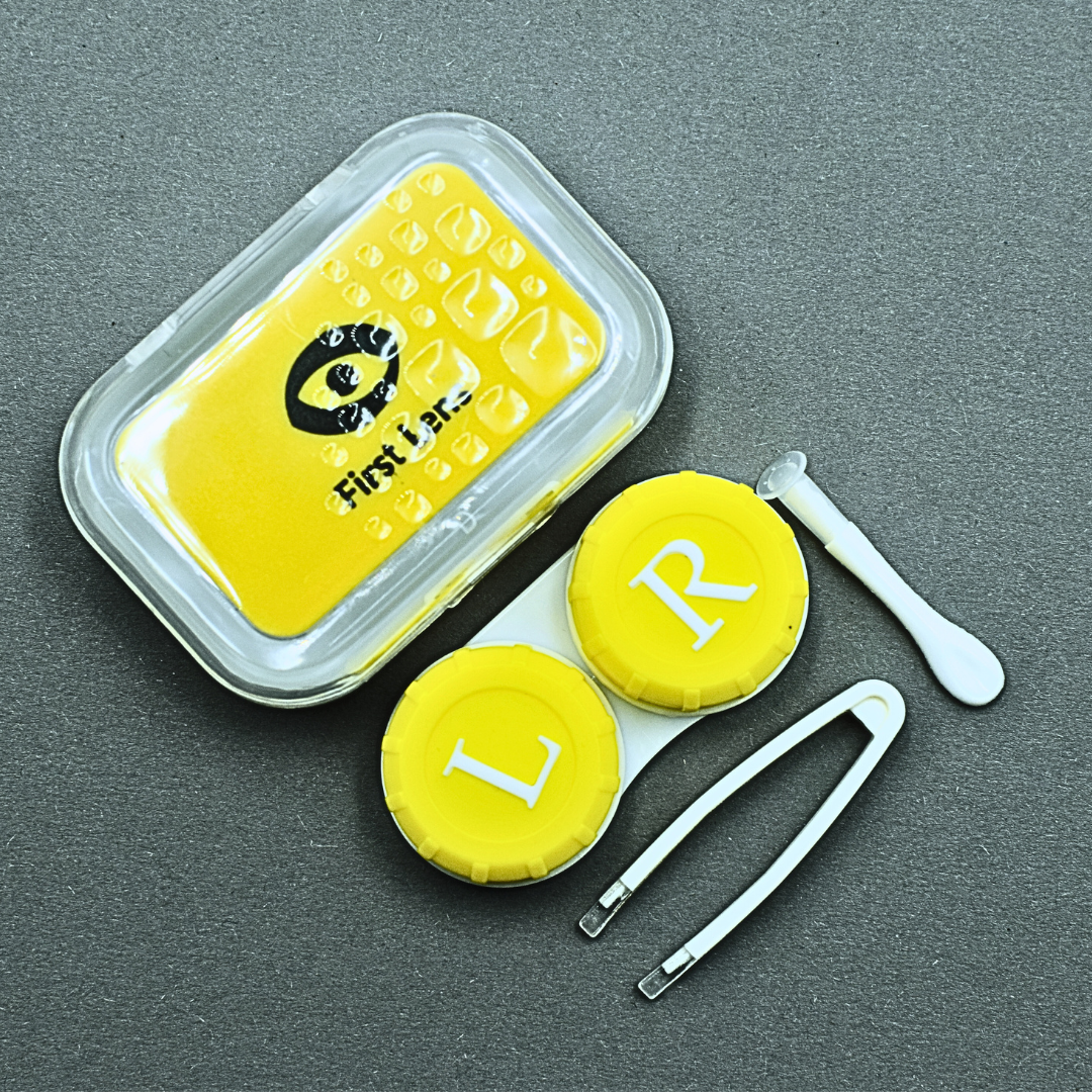A product demonstration image featuring the First Lens Crystal Portable Contact Lens Case open with lenses inside, highlighting its functionality and ease of use.
