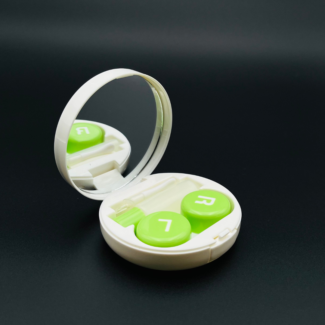A cute kiwi-shaped contact lens case by First Lens, ideal for travel or everyday use.