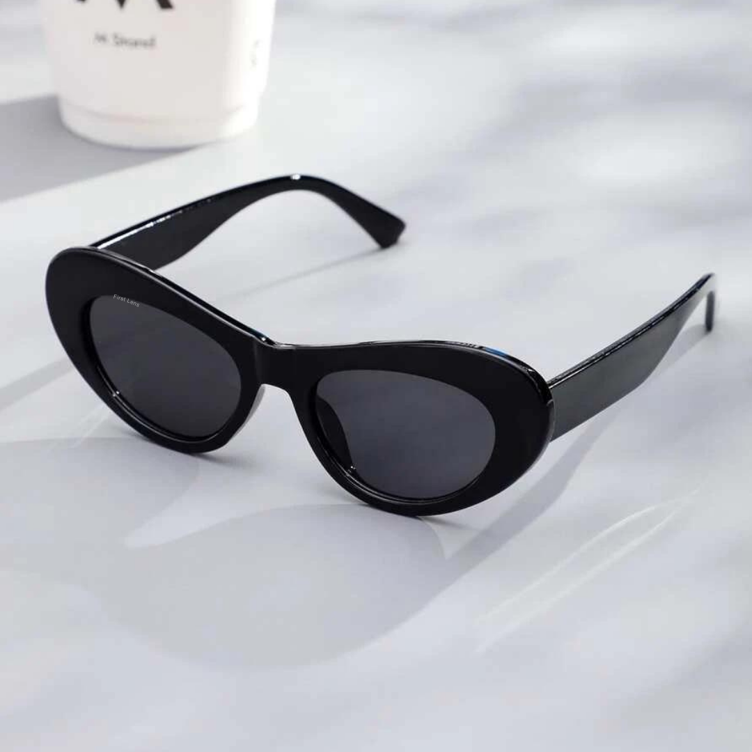 First Lens oval-shaped sunglasses with black frames, tinted lenses