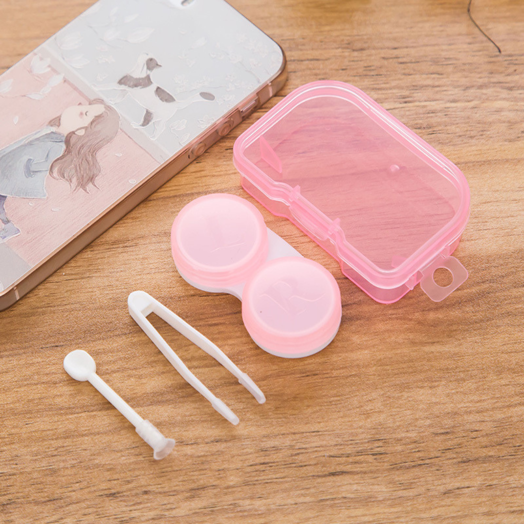 A top-down view of three transparent First Lens contact lens cases arranged neatly in a row, emphasizing the pack of three included in the kit.